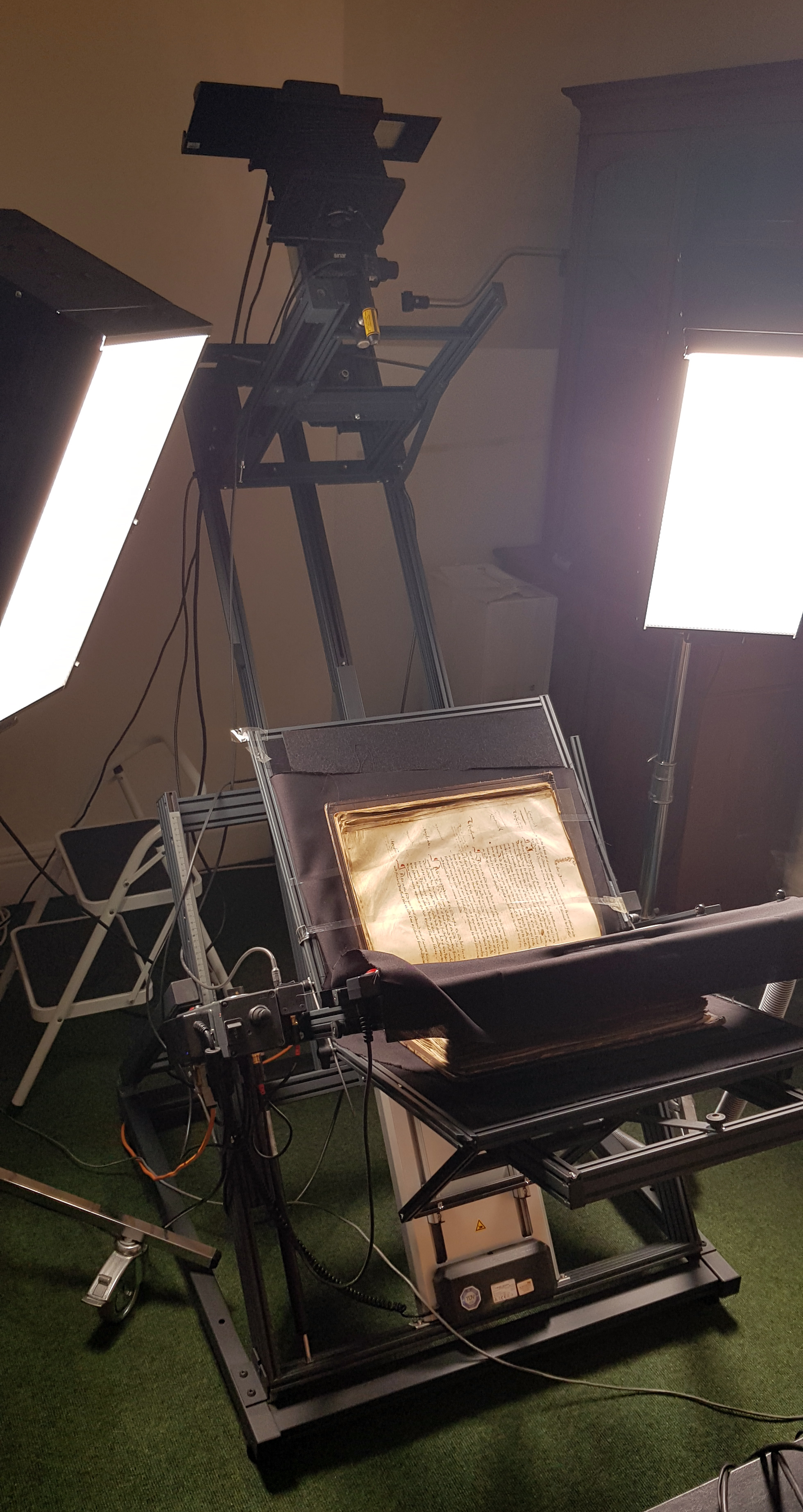 Grazer conservation graded book cradle with manuscript in place and lights